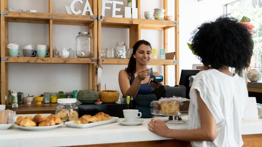Cashier and patron in a bakery cafe