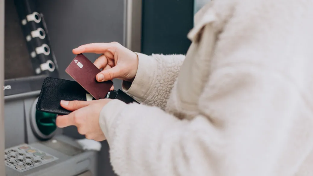 detail acquiring partners woman withdrawing money atm outside street