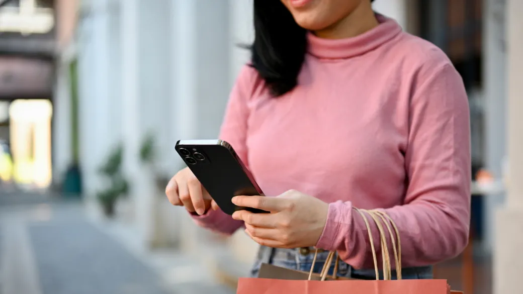 detail payment processing global woman carrying her shopping bags