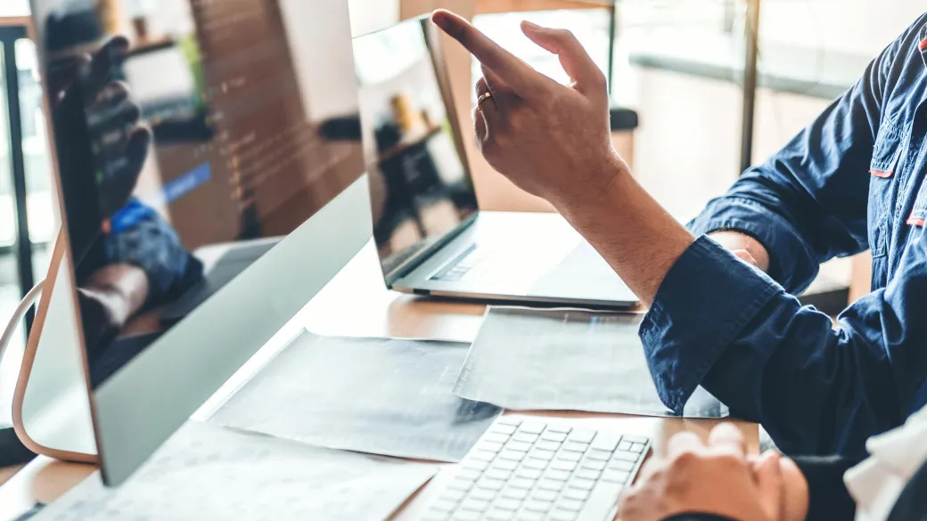 Programmers collaborating analyzing code