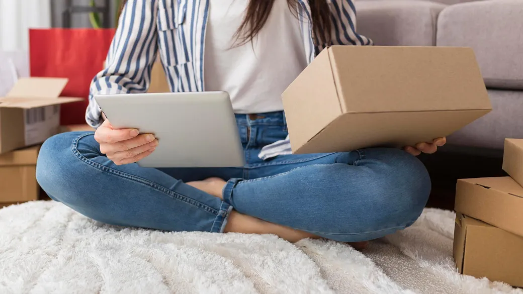 Lady with tablet preparing parcel