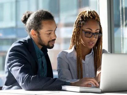 man and woman at laptop
