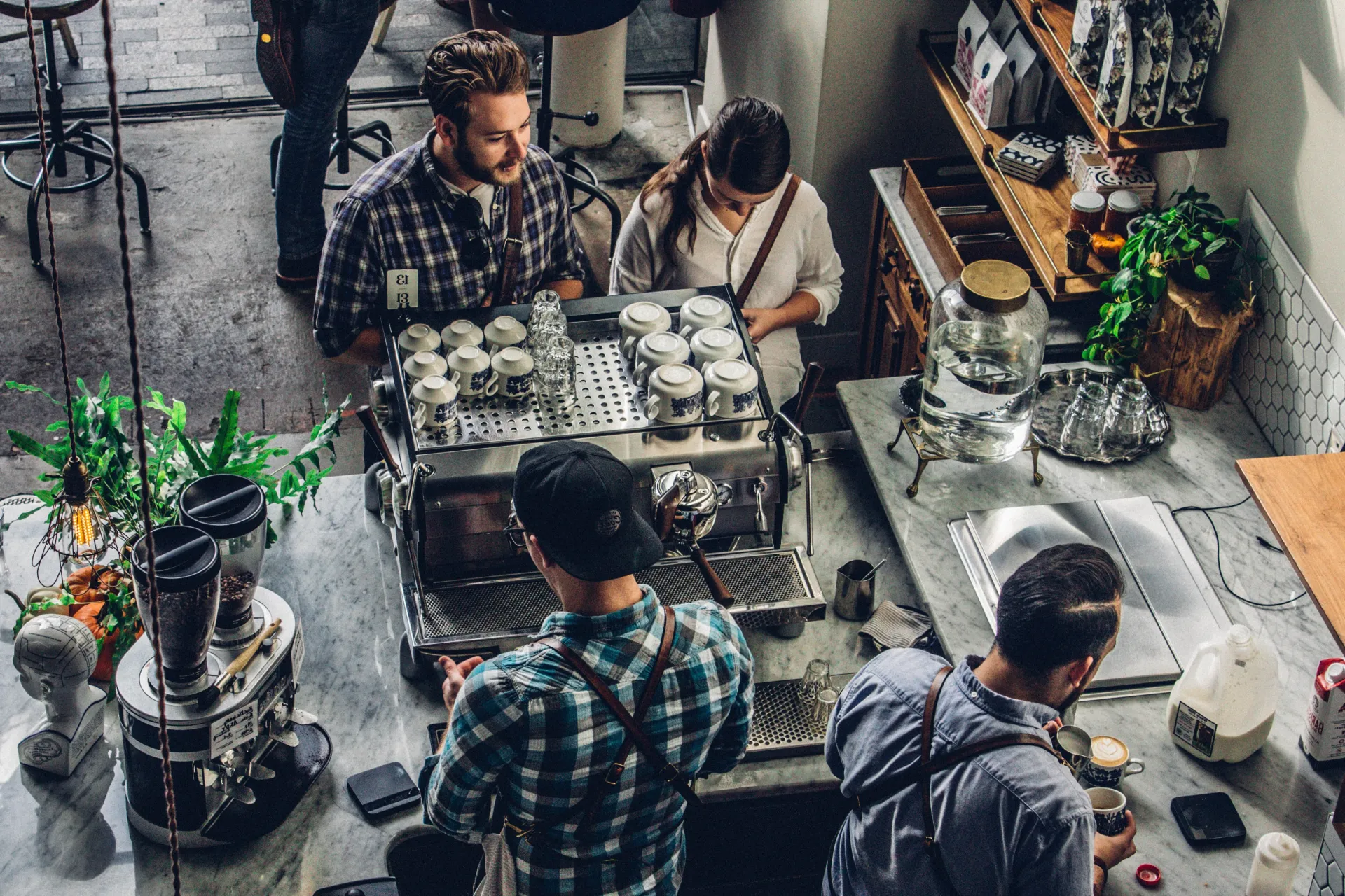 Customers at a coffee counter with baristas