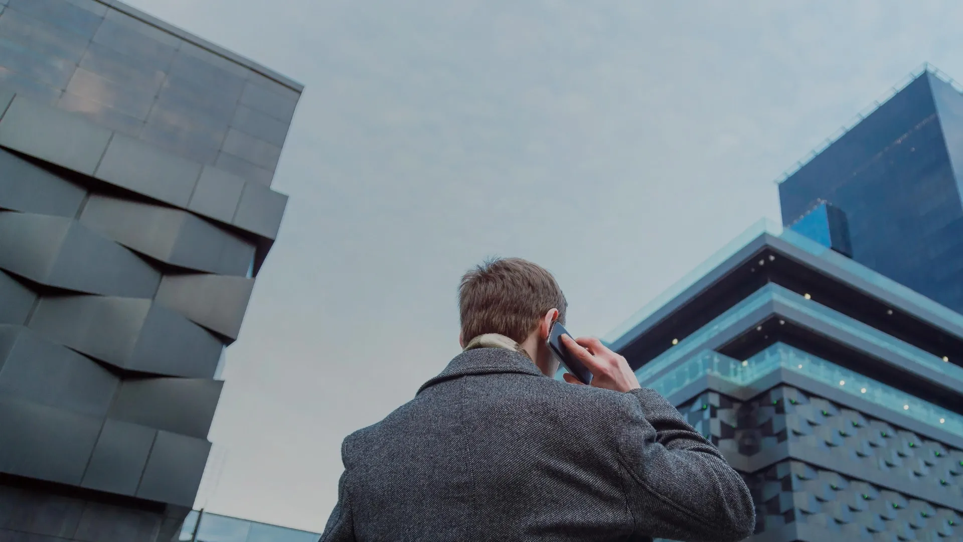 Business man talking mobile skyscraper