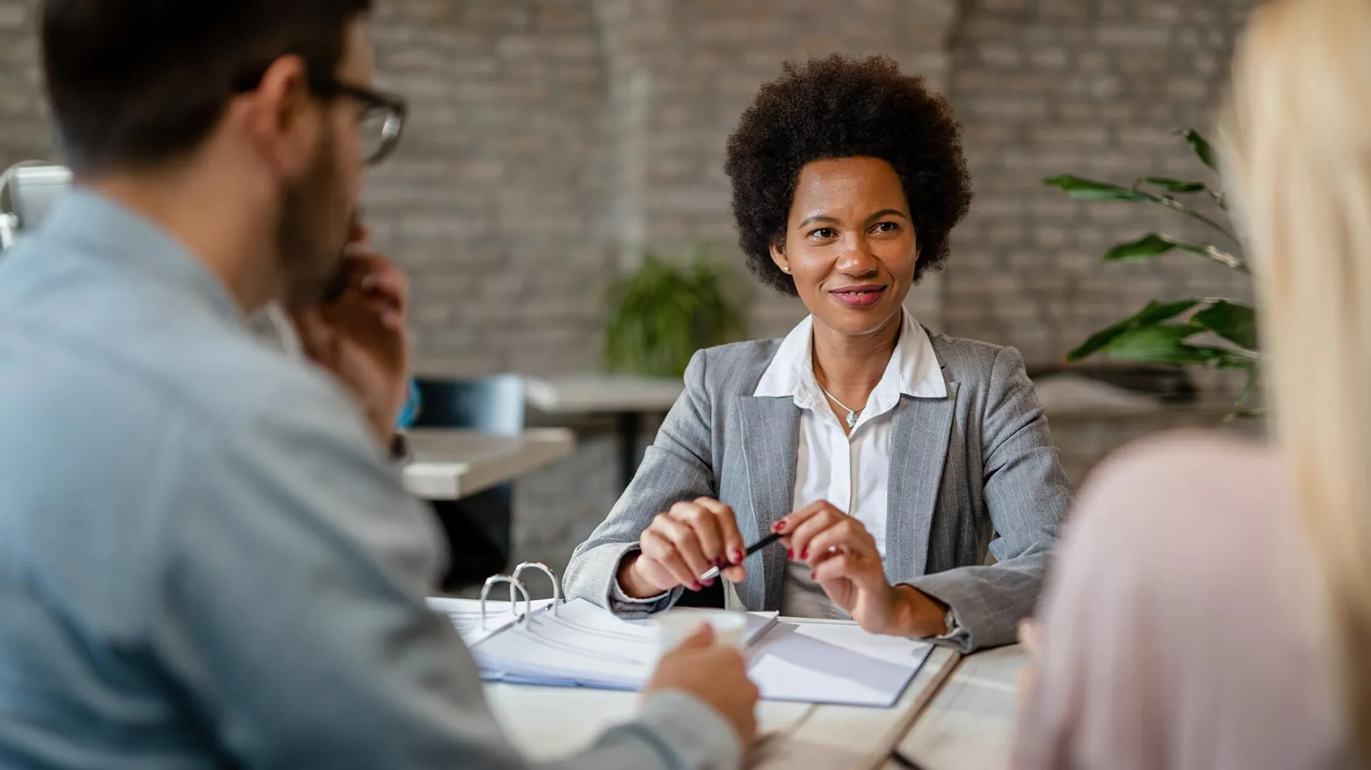 Woman advising couple on finance