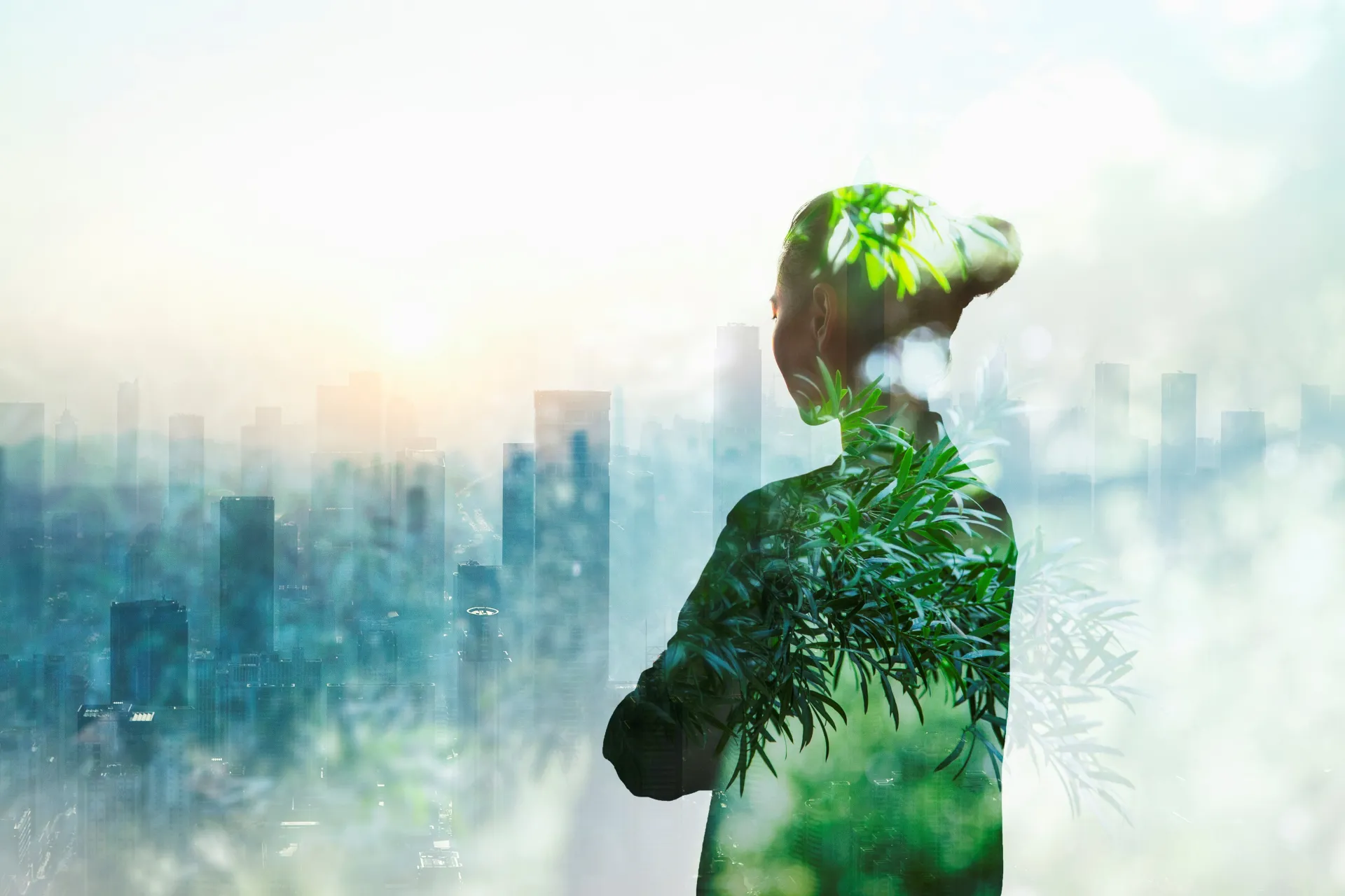 Woman looking at a city - trees in the background