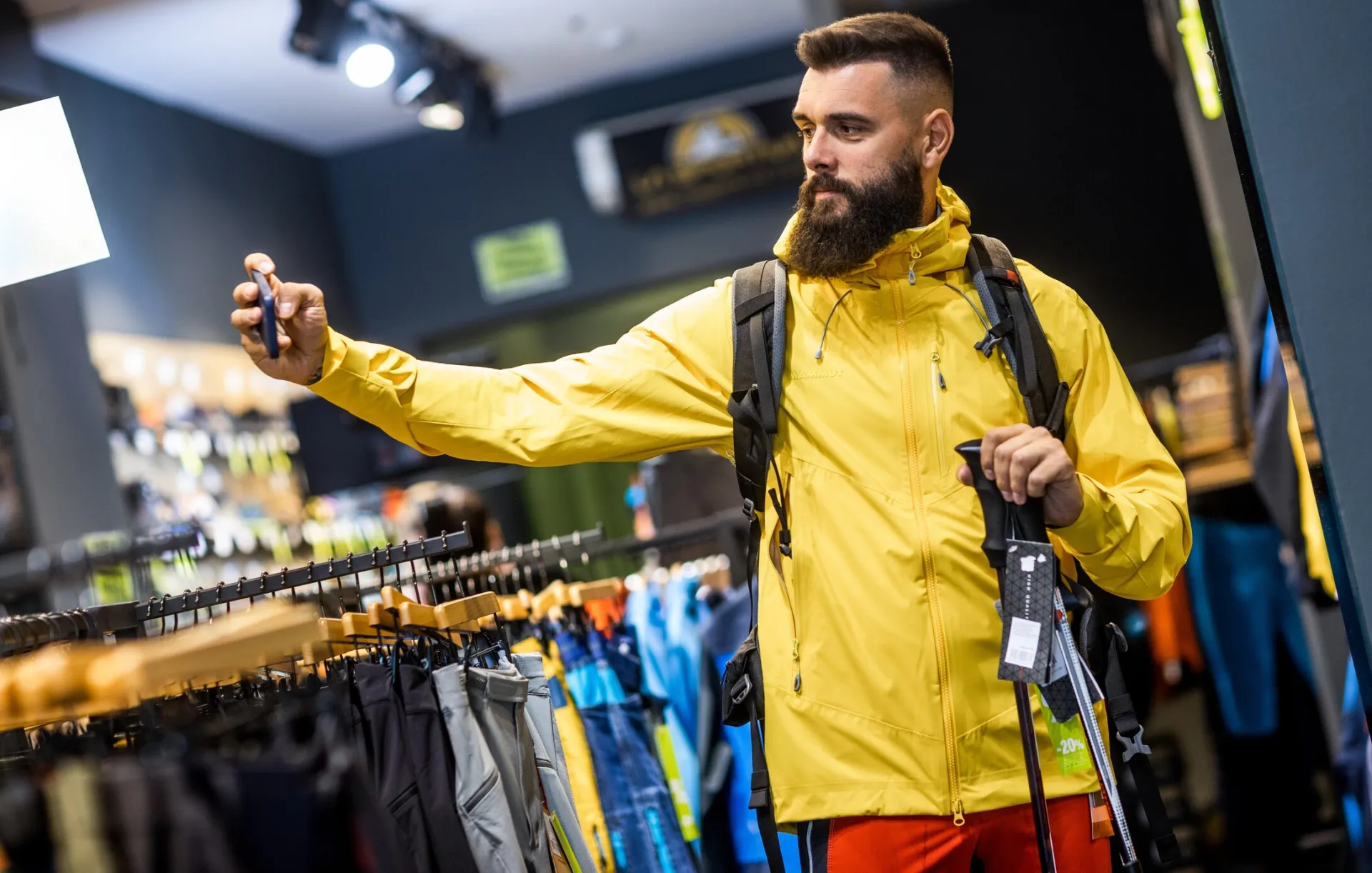 Man in sporting goods store taking a selfie