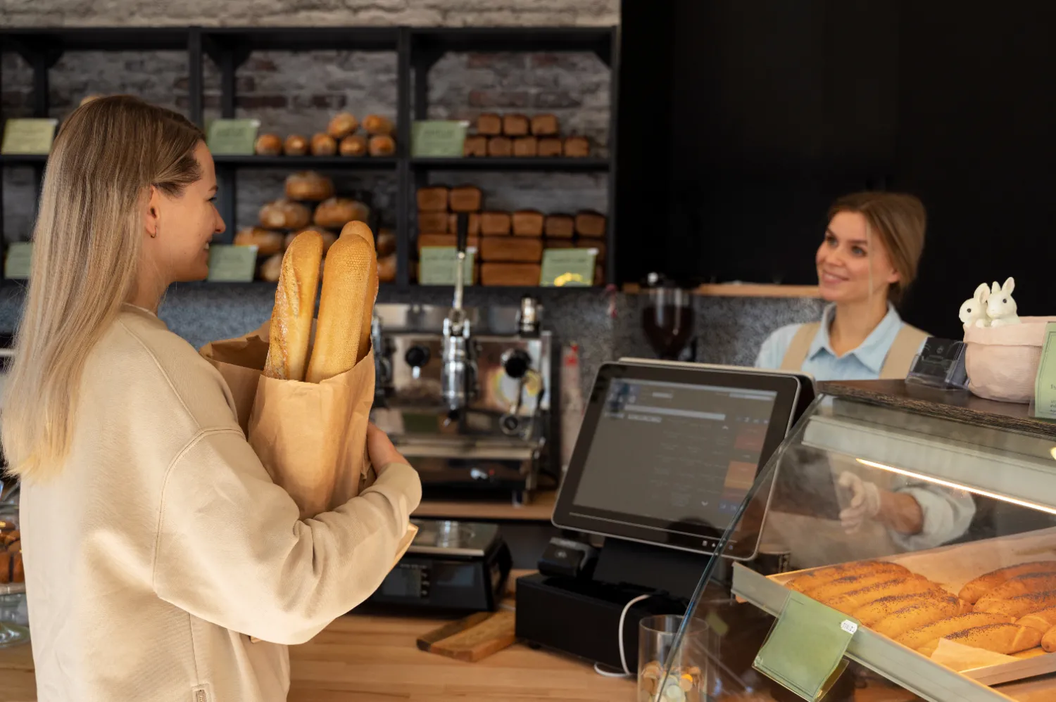 Shopper at cash register with groceries