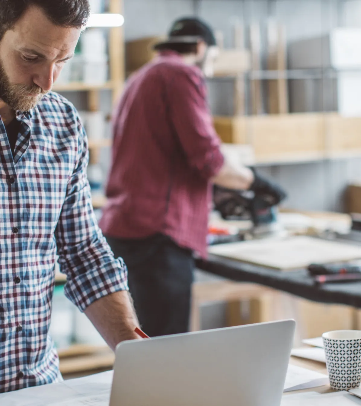Man with computer in custom workshop