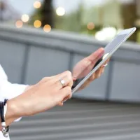 detail payment processing woman uses tablet