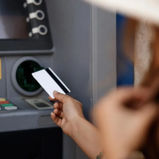 Lady casually using ATM