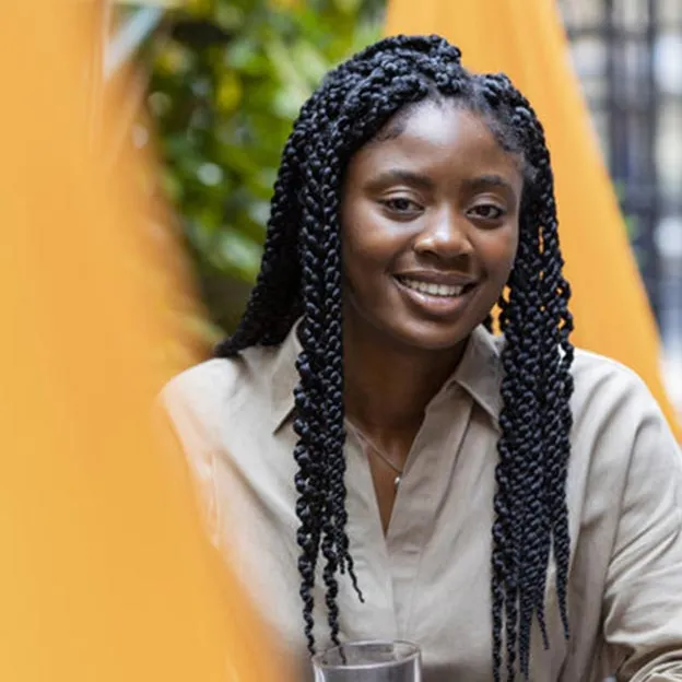 Young woman outdoors with a glass of juice