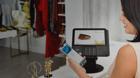 Young woman paying with mobile wallet
