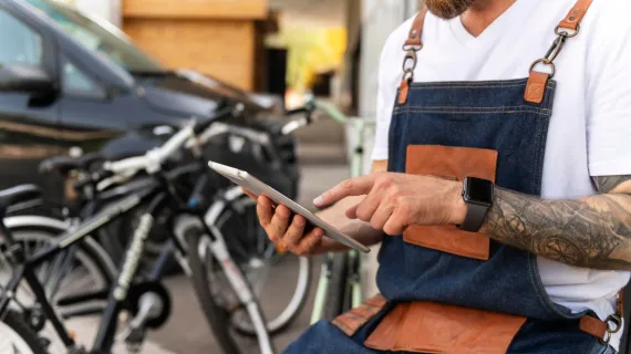 detail self service onboarding close up young businessman bike shop