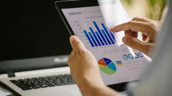 Digital business growth charts on tablet