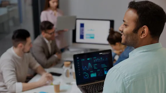 Business man holding laptop in meeting room
