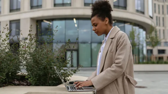 person cloud services hispanic young female administrator working remotely laptop street